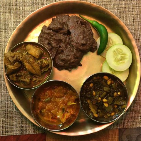 Traditional Nepali dish Dhido served with gundruk, pickles, and chicken soup, highlighting authentic Himalayan cuisine.