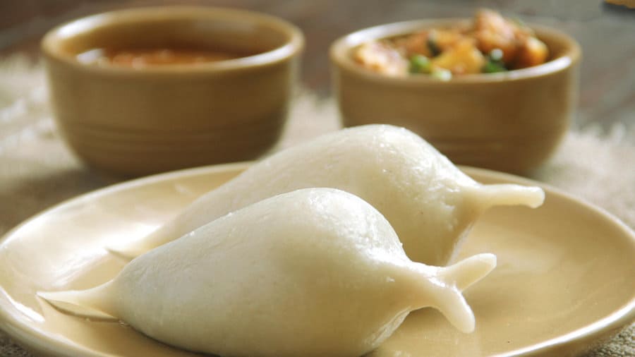 Steamed Yomari filled with sweet molasses and sesame seeds, a traditional Newari delicacy from Nepal served during festivals.