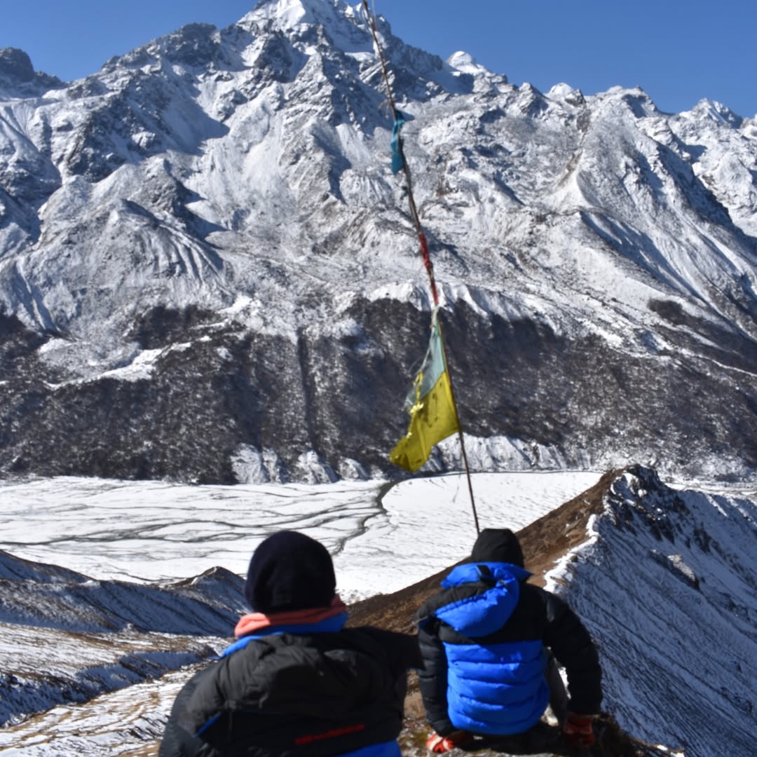 Scenic view of Langtang Valley with lush green meadows, snow-capped peaks, and a serene trekking trail, capturing the charm of the Langtang Valley Trek.