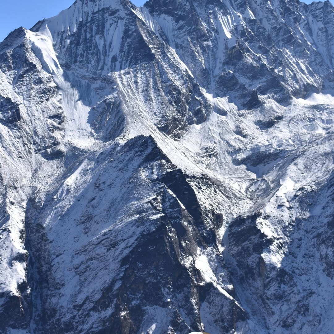 Breathtaking mountain view of Langtang Valley during spring, with lush greenery, rhododendron treeks and clear skies, perfect for a springtime trek.