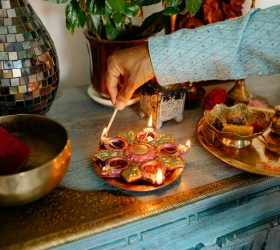 Man lighting decorative candles during Tihar, a major festival of Nepal